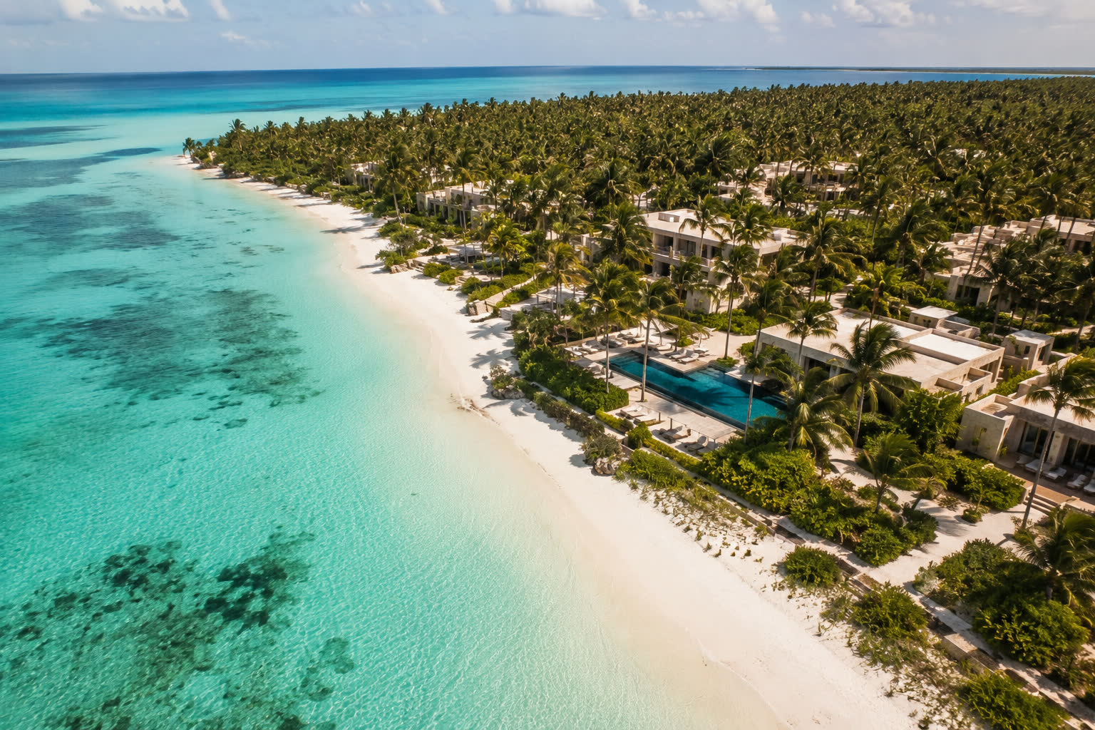 Aerial view of the Michamvi first line: lagoon, white beach and villas among the palms